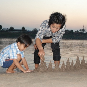 Dad and kid making sandcastle